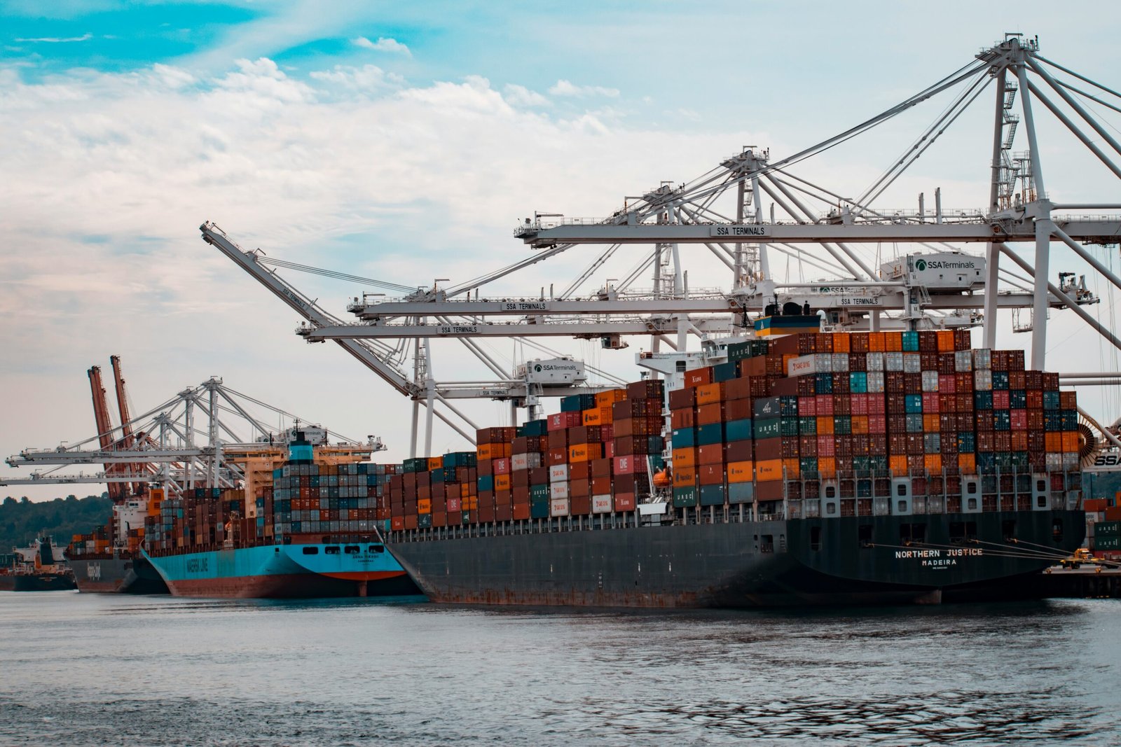 cargo ships docked at the pier during day